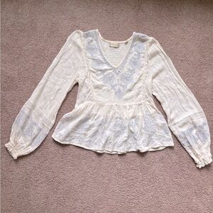 Elegant cream long sleeve top with light blue embroidery